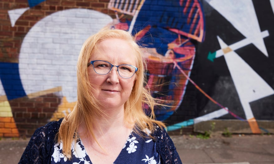 Kim Oliver before a visually jarring mural.
