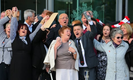 Relatives, survivors and supporters celebrate as they leave the inquests in Warrington. 