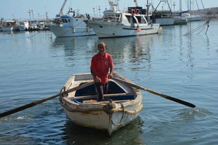 Rowing the catch ashore in Scoglitti harbour, Sicily.