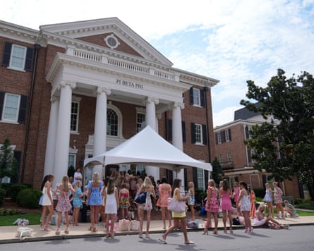 Sorority recruits line the sidewalk of sorority row at the University of Alabama, Thursday, Aug. 14, 2025, in Tuscaloosa