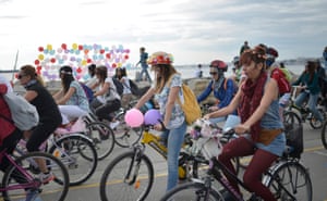 Turkish women ride their bikes during a parade to celebrate World Car-Free Day in Istanbul