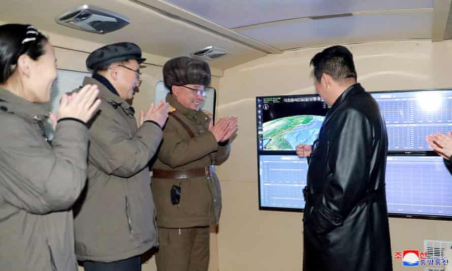 North Korean leader Kim Jong Un (R) speaking with military officials during an observation of what state media says a hypersonic missile test-fire