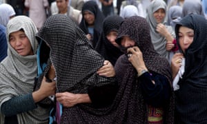 Afghan women mourn during the funeral of victims of the Kabul bombing.