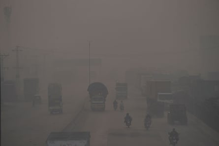 Vehicles make their way over a bridge amid heavy smog in Lahore.