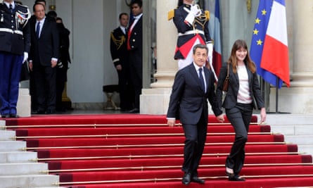Nicolas Sarkozy and Carla Bruni leaving the Elysée palace in May 2012, as François Hollande looks on.
