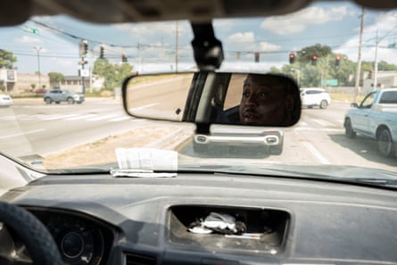 A man looks out of his rearview mirror