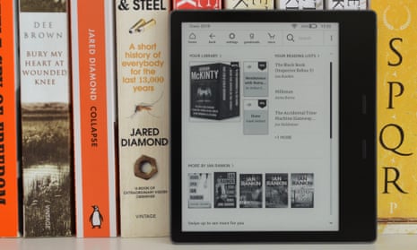 An Amazon Kindle e-reader on a bookshelf.
