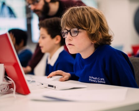A schoolboy concentrates on a computer screen