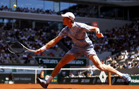 Jannik Sinner stretches for a backhand return to Juan Manuel Cerundolo.