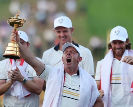 Team Europe’s Rory McIlroy celebrates with the trophy