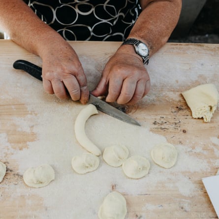Semolina dough is rolled into thin, snake-like rolls.
