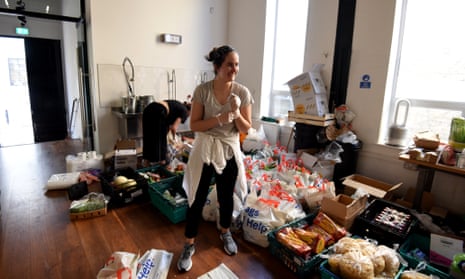 A volunteer from a Mutual Aid group in Islington, north London, prepares food parcels.