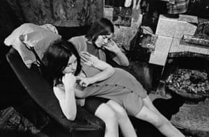 Glasgow, 1970. Sisters sharing a chair in a Gorbals slum tenement