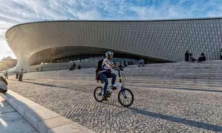 Cyclist passes the MAAT - Museum of Art, Architecture and Technology, Lisbon