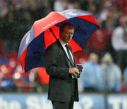 England head Steve McClaren pinch a ample reddish and navy striped umbrella against Croatia astatine Wembley successful 2007