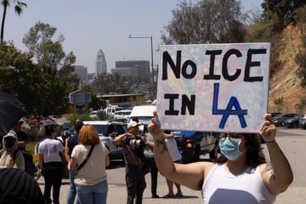 A protester with a banner outside Dodger Stadium in Los Angeles demands an end to immigration raids.