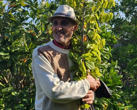 Amjed Tantesh, Malak’s father, hugs the tree he planted before the beginning of the war in Beit Lahiya after finding it had grown.