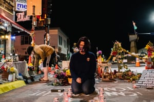 Courteney Ross, girlfriend of George Floyd, lays candles at the intersection of 38th St & Chicago Ave in Minneapolis before the trial of former police officer Derek Chauvin.