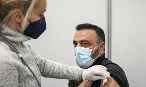 A man gets his vaccination at a vaccination Drive-in center in Cologne, Germany, Tuesday, Nov. 23, 2021.