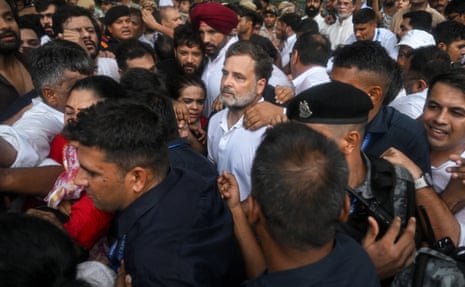 Officers detain Rahul Gandhi among a crowd