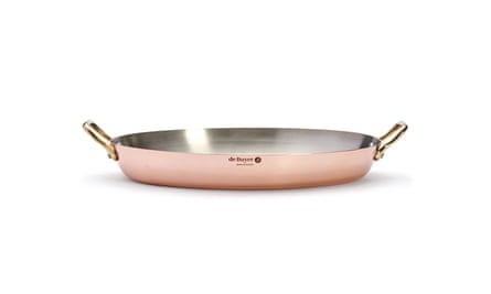 A large copper dish with brass handles