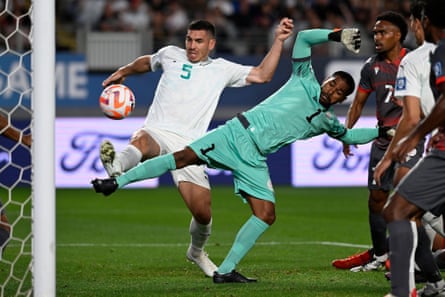 New Caledonia’s goalkeeper Rocky Nyikeine blocks a shot from New Zealand’s Michael Boxall