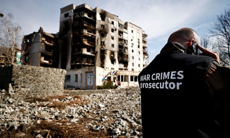 A war crimes prosecutor near buildings destroyed by Russian shelling in Borodyanka, Kyiv region.