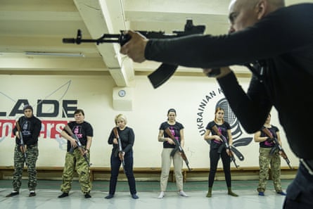 An instructor shows a group of women how to use weapons during training in Kharkiv, 30 January