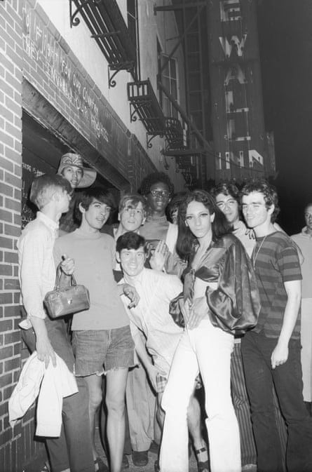 A group of young people–including Tommy Lanigan -Schmidt on the far right–celebrate outside the boarded-up Stonewall Inn (53 Christopher Street) after riots over the weekend of June 27, 1969.