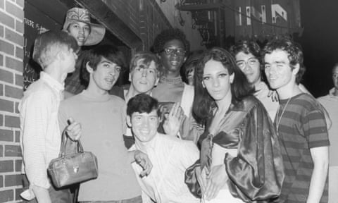 A group of young people – including Tommy Lanigan -Schmidt on the far right – celebrate outside the boarded-up Stonewall Inn after the riots.