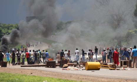 Zimbabwean protesters block a major road leading into the city centre of Harare.
