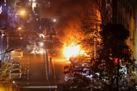 Cars burn in a street on 8 January during a protest in Tehran.