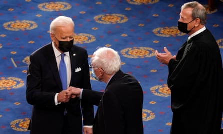 Biden greets Sanders as Chief Justice John Roberts watches at the US Capitol in April 2021.