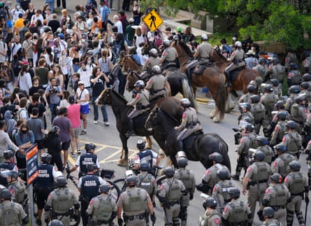Protesters pushed back by police on horseback