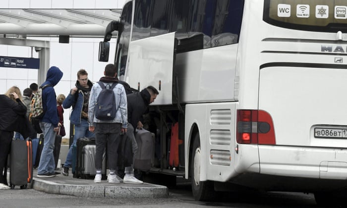 Passengers get off a coach coming from St Petersburg, Russia, after it arrived at Helsinki airport in Finland.