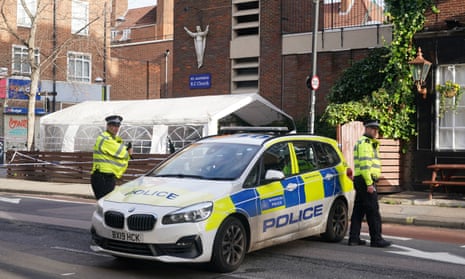 Police at the scene of a shooting outside a memorial service held in St Aloysius Roman Catholic church in Euston, north London.