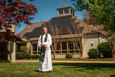 The Rev Scott Hardin-Nieri in front of the solar panels at the First Christian church in Black Mountain, North Carolina. 