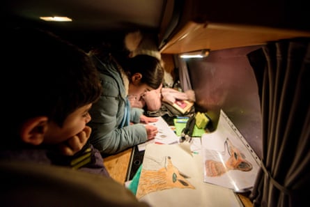 Refugee children draw animals while waiting for foxes to show up in Spandau.