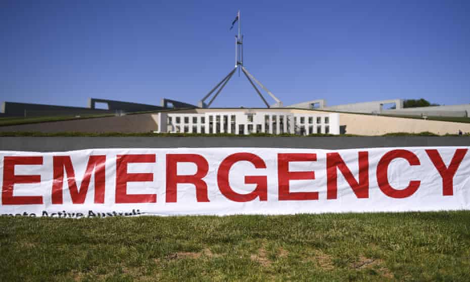 A banner from a climate action rally outside Parliament House in Canberra on Monday
