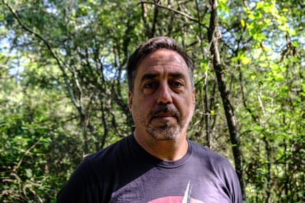 A man in front of a tree canopy