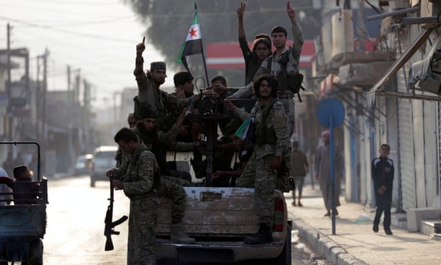 Turkey-backed Syrian rebel fighters in the border town of Tal Abyad. The US-Turkey agreement calls for a 120-hour ceasefire in a “safe zone”.