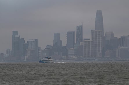 San Francisco skyline is enveloped in smoke from wildfires a a boat moves across the bay in September 2023.