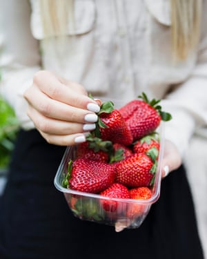 Young Woman Eating Strawberries