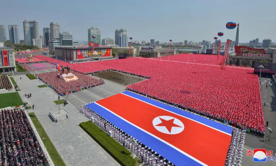 North Koreans march in the centre of Pyongyang to celebrate the 110th birthday of Kim Il-sung.