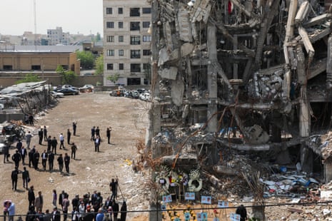 people look at a destroyed building