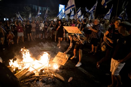 Protesters feed a bonfire during a demonstration near the Israeli Knesset in Jerusalem on Monday.