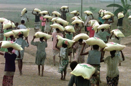Villages from the Western Province of Papua New Guinea carry emergency food supplies delivered in a time of drought.
