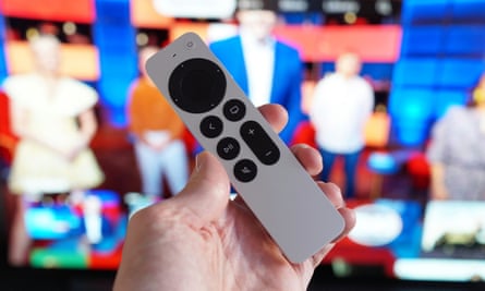 The Siri remote pictured in front of a TV screen