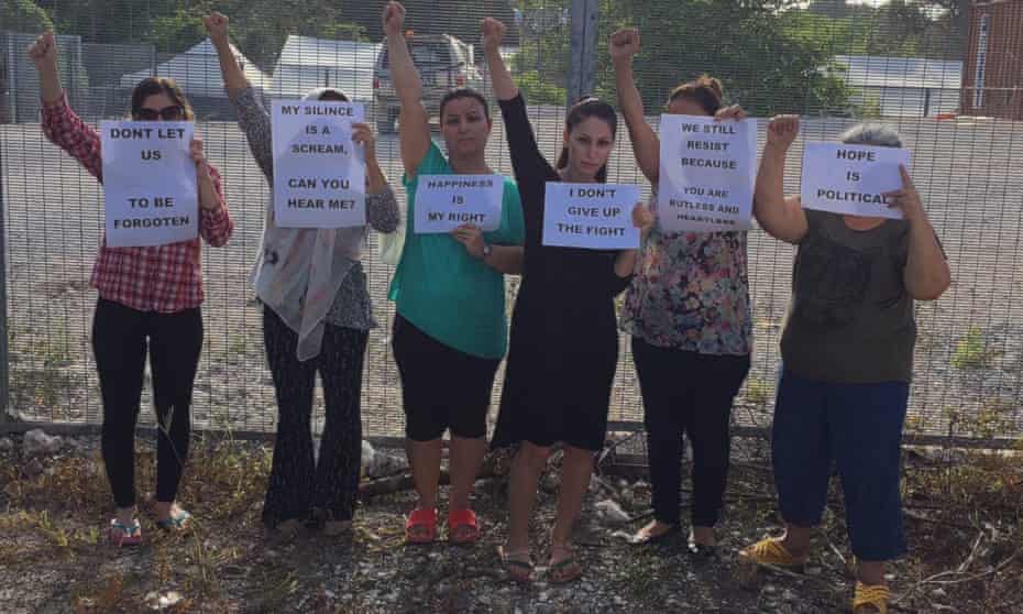Iranian asylum seekers currently in Nauru detention centre hold up feminist signs 