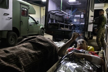 Evgeniy, 24, smokes a cigarette before his transfer onward to Dnipro along with other military patients after a traumatic amputation to his foot caused by an exploding mine on 7 October 2022 in Donetsk District, Ukraine
